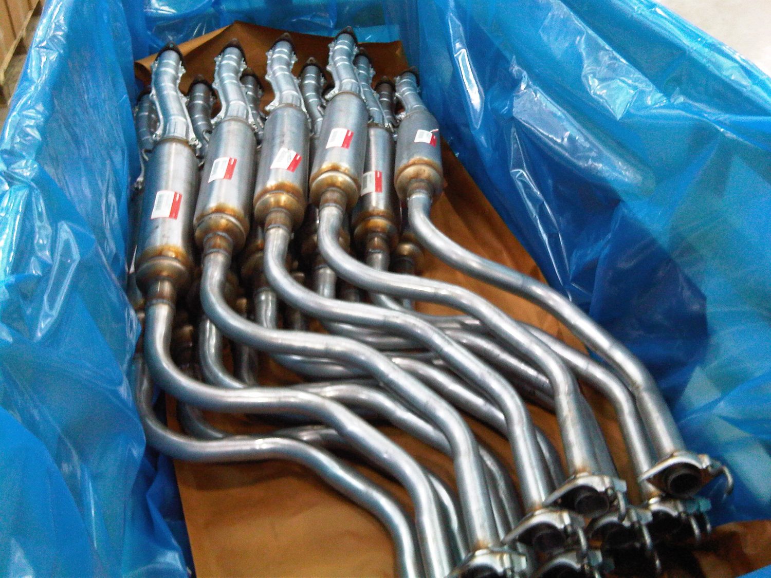 Automotive exhaust components packed in VCI film and paper