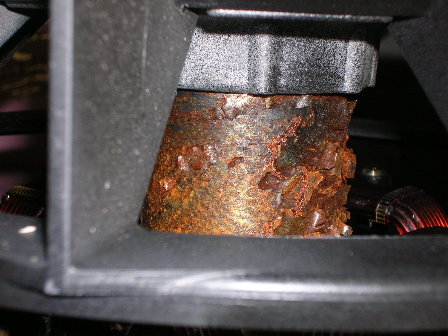Severe rust flaking on a corroded metal component