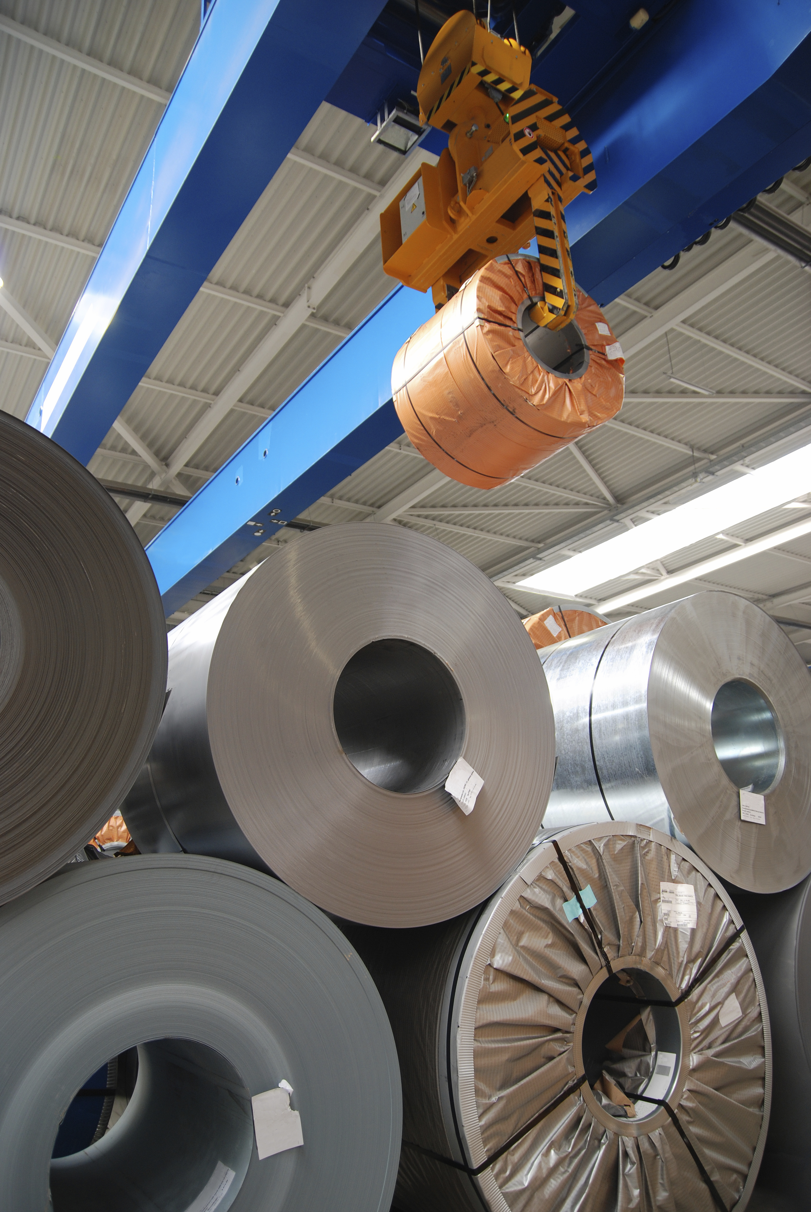 Coils of steel and metal stock stored in a warehouse ready for VCI protective packaging